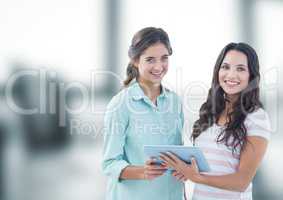 Smiling businesswomen with tablet PC in office