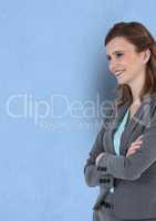 Happy thoughtful businesswoman standing arms crossed against blue background