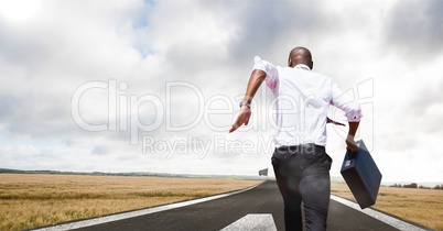 businessman running to the checker flag with his briefcase
