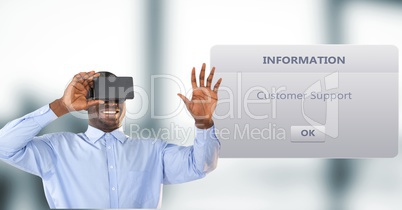 Smiling businessman using VR Glasses by dialog box in background