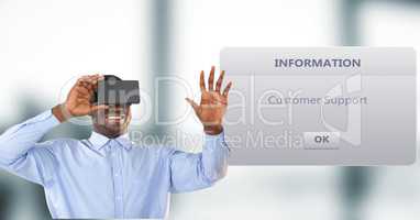 Smiling businessman using VR Glasses by dialog box in background