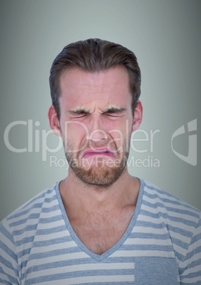 Man crying against light blue background