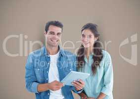 Smiling man and woman with tablet over color background