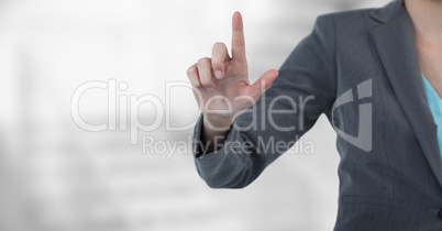 Midsection of businesswoman touching screen