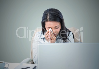 Woman crying at computer against light blue background