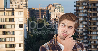 Thoughtful man with hand on chin in city