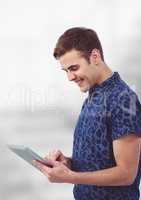 Smiling young man using tablet PC