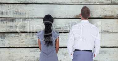 Rear view of business people standing against wall