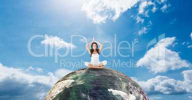 Woman meditating on earth against sky