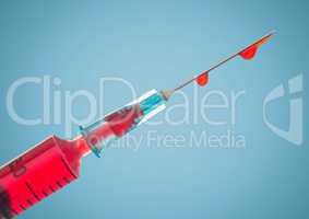 Syringe with red liquid against blue background