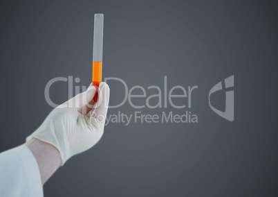 Gloved hand with tube against grey background
