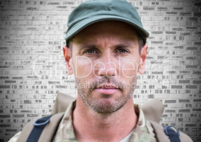 Soldier face with grunge overlay against brick wall