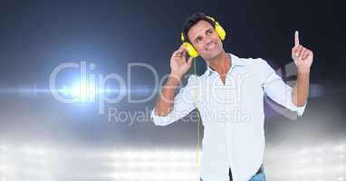 Happy man listening music through headphones