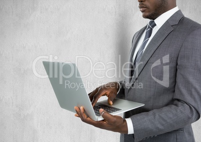 Midsection of businessman using laptop