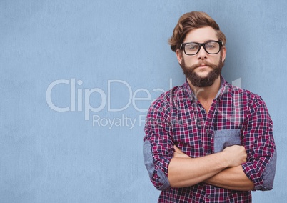 Confident hipster standing arms crossed over blue background