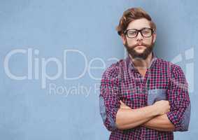 Confident hipster standing arms crossed over blue background