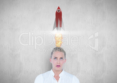 Businesswoman with rocket over head