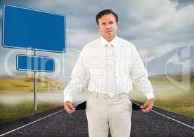 Businessman with empty pockets on road by blank signs