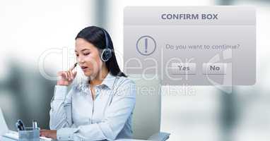 Customer service representative using headphones by dialog box