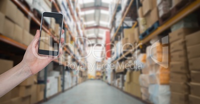 Hand photographing goods in warehouse