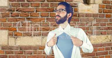 Hipster tearing shirt against brick wall