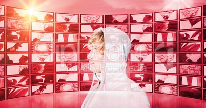 Digital composite image of hacker against screens