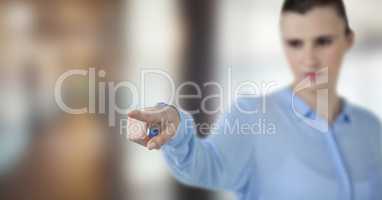 Businesswoman pointing over blurred background