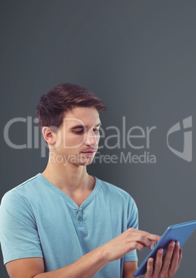 Male hipster using digital tablet against gray background