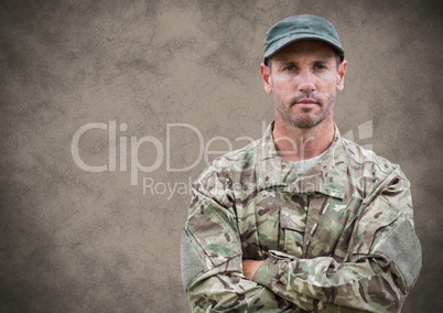Soldier arms folded against brown background with grunge overlay