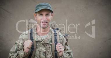 Soldier with backpack against brown background with grunge overlay