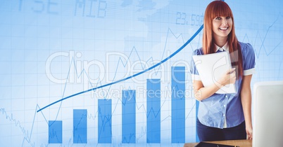 Portrait of smiling businesswoman holding document while standing against graph background