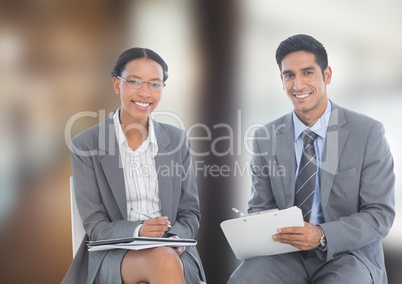 Portrait of happy business colleagues sitting in office