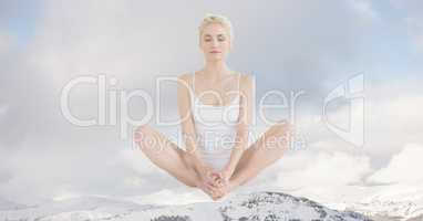 Double exposure of woman meditating on snowcapped mountain