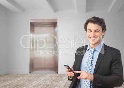 Happy businessman using mobile phone in office