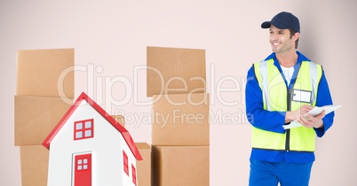 Delivery man standing by 2d house and parcels