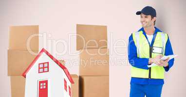 Delivery man standing by 2d house and parcels