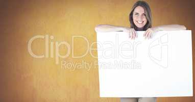 Portrait of woman holding blank billboard against yellow background