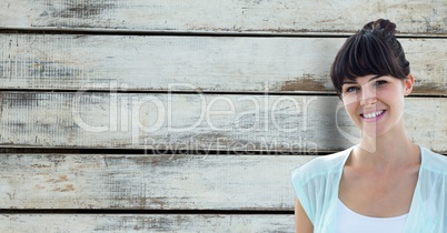 Portrait of smiling female hipster against wooden wall