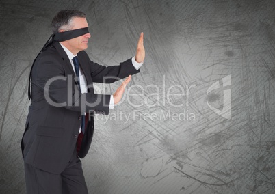 Business man blindfolded with grunge background