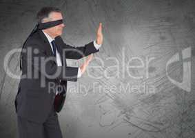 Business man blindfolded with grunge background