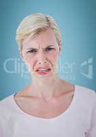 Woman with angry face against blue background