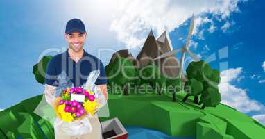 Smiling delivery man showing parcel against trees and windmill