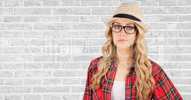 Female hipster wearing hat against wall
