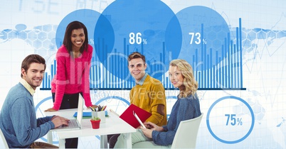 Male and female hipsters at desk with graphs in background