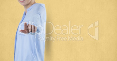 Midsection of female professional pointing against beige background