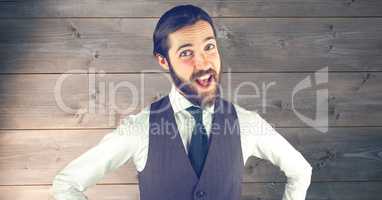 Happy hipster in formals against wooden wall