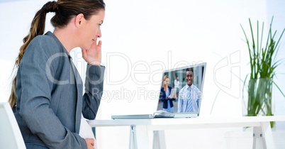 Businesswoman video conferencing with partners on computer