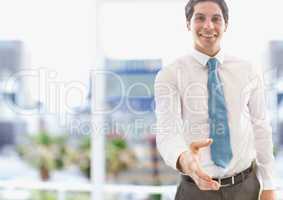 Portrait of confident businessman offering handshake