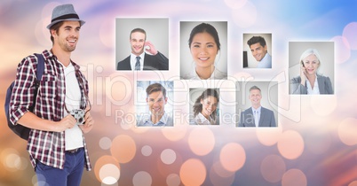 Happy male photographer looking at flying business portraits