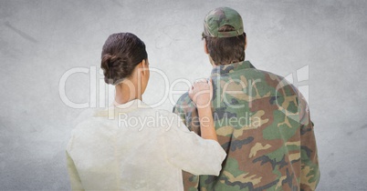 Back of soldier and wife against white wall with grunge overlay
